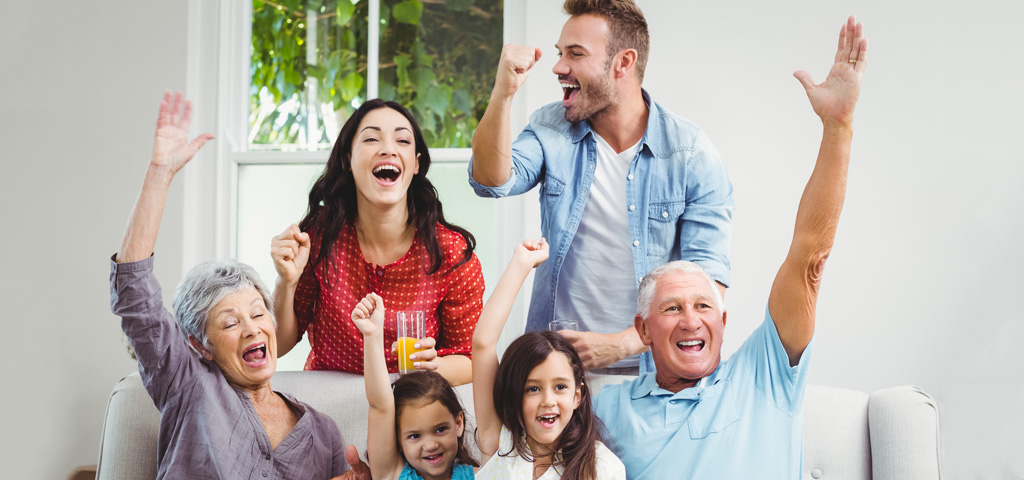 A multi-generational family cheering